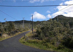 Narrow but paved Kalako Drive, zigzagging up toward antennas on west slope of Hualalai volcano