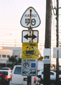 Rusted and stickered old cutout-style junction marker for former route 90, at junction with Kalihi Street