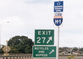 Old hypenated H-1 shield at ground level, painted on white background, no state name