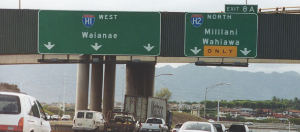 Overhead signs on westbound H-1, approaching exit for northbound H-2
