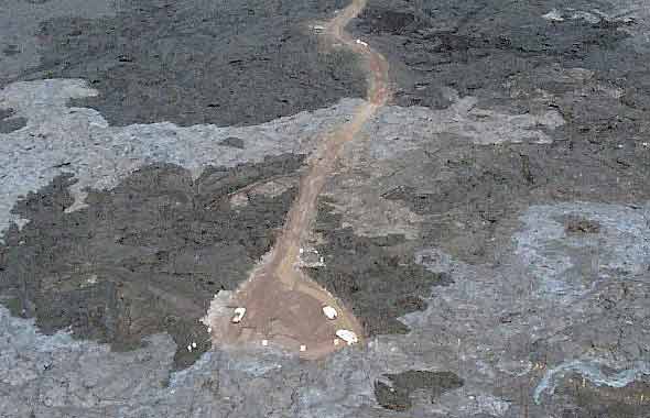 Southwest end of lava access road in Sept. 2001, crossing silvery finger of recent lava flow, ending in turnaround area, with marked trail to lower right