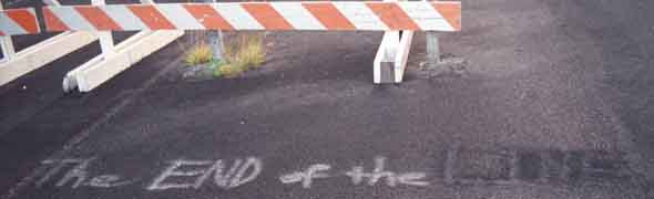 'The END of the LINE' chalked onto pavement in front of barricade