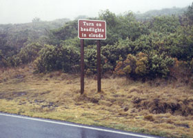 Fog warning sign on Haleakala Crater Road -- Turn On Headlights In Clouds