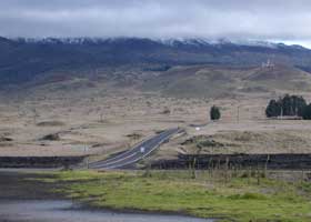 John A. Burns Way approaching cloud-enshrouded Mauna Kea, with two smooth lanes of pavement and a 40mph speed limit