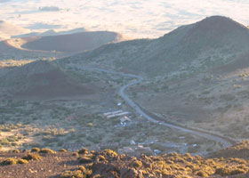 View from above of the visitor center and nearby astronomy support facilities, as well as part of the access road