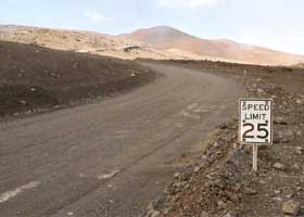 'Speed Limit 25' sign, mounted low to ground and with six holes