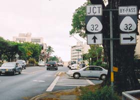 'By-pass' 32 route marker in downtown Wailuku, next to route marker indicating main route is ahead