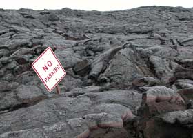 'No parking' sign sticking out of solidified lava
