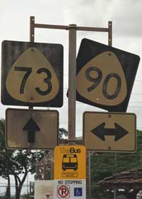 TheBus stop marker at bottom, beneath old route 73 route marker for southbound thru traffic, and route 90 marker for cross-street