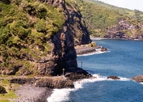 Road hugging the cliff near sea level