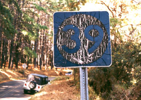 Aged old Route 39 sign (black on white circle on black square)