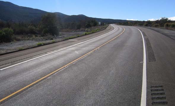 New Ala Mauna Saddle Road alignment facing eastbound, with reflectors embedded in the road and rumble strips on the shoulders