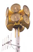 Civil defense sirens, a dozen yellow horns pointing outward in six different directions